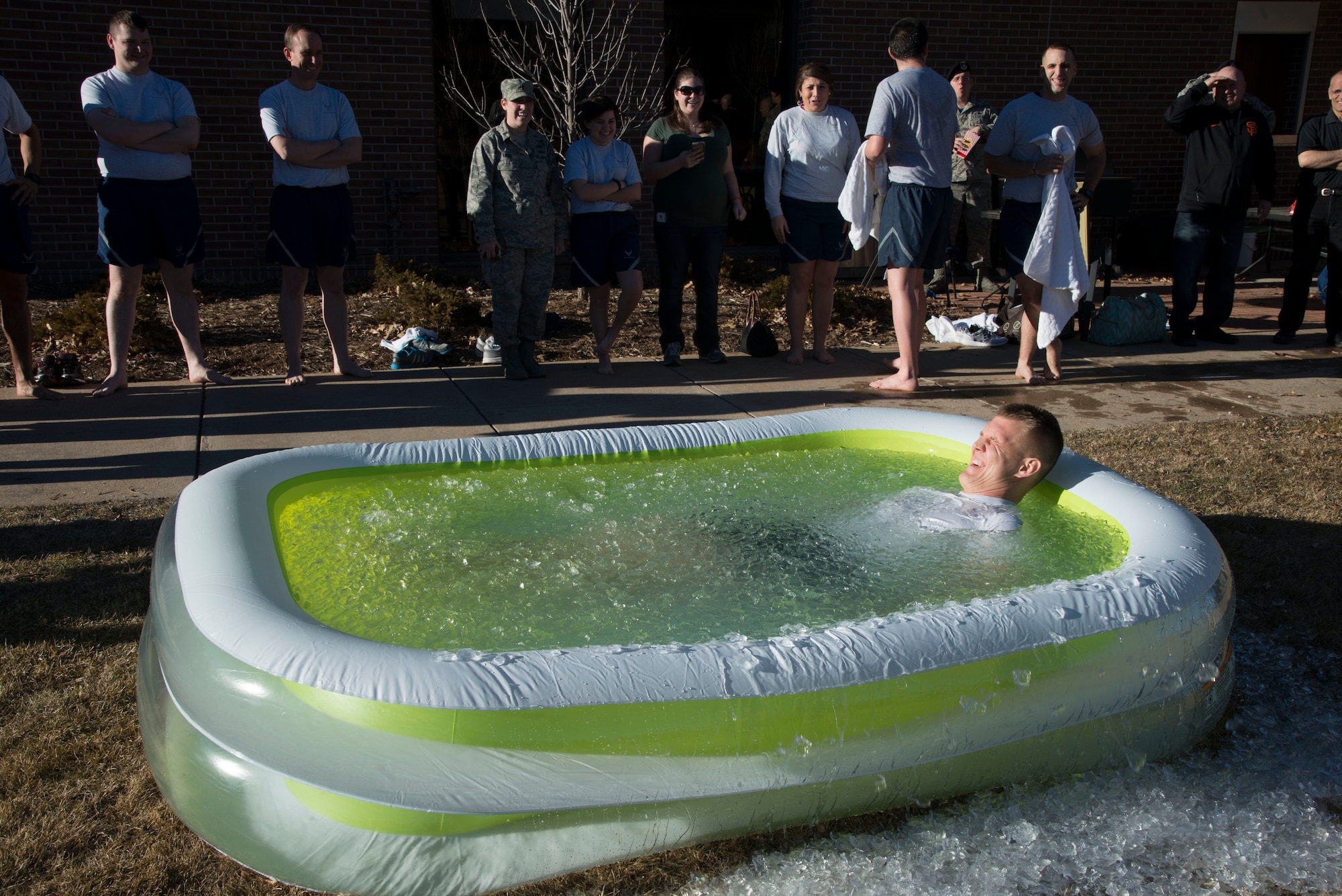 PETERSON AIR FORCE BASE, Colo. – Chaplain (Capt.) Joshua Flynn, 21st Space Wing Chapel, braves the ice-cold water during the January Final Friday Polar Ice Challenge on Jan. 29, 2016 at the Peterson Club. January’s Final Friday was themed the Thule Experience and included 11 participants braving the pool. (U.S. Air Force photo by Tech. Sgt. Jared Marquis) 