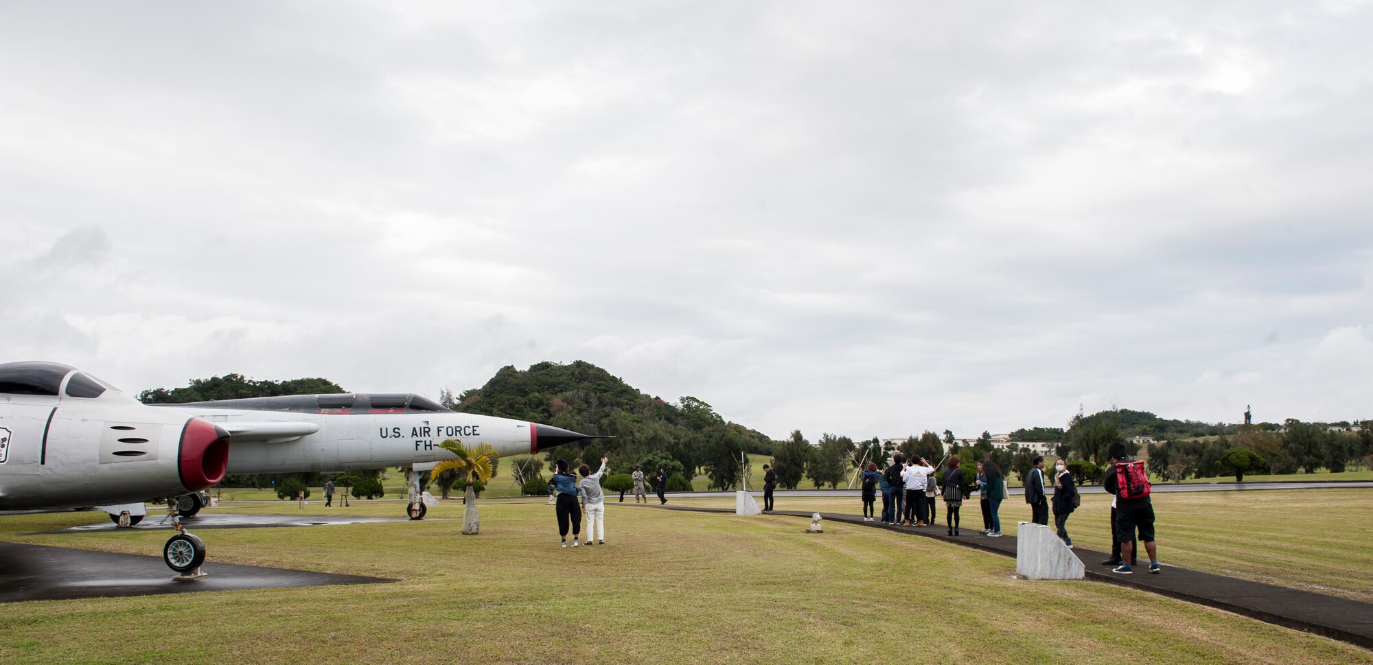 Okinawa International University students look at static aircraft displays Feb. 5, 2016, at Kadena Air Base, Japan. The students were invited to learn about Kadena’s mission, aircraft and people. Their tour consisted of visits to the 18th Security Forces Squadron, the Peace Park and Habu Trail. (U.S. Air Force photo by Airman 1st Class Lynette M. Rolen)