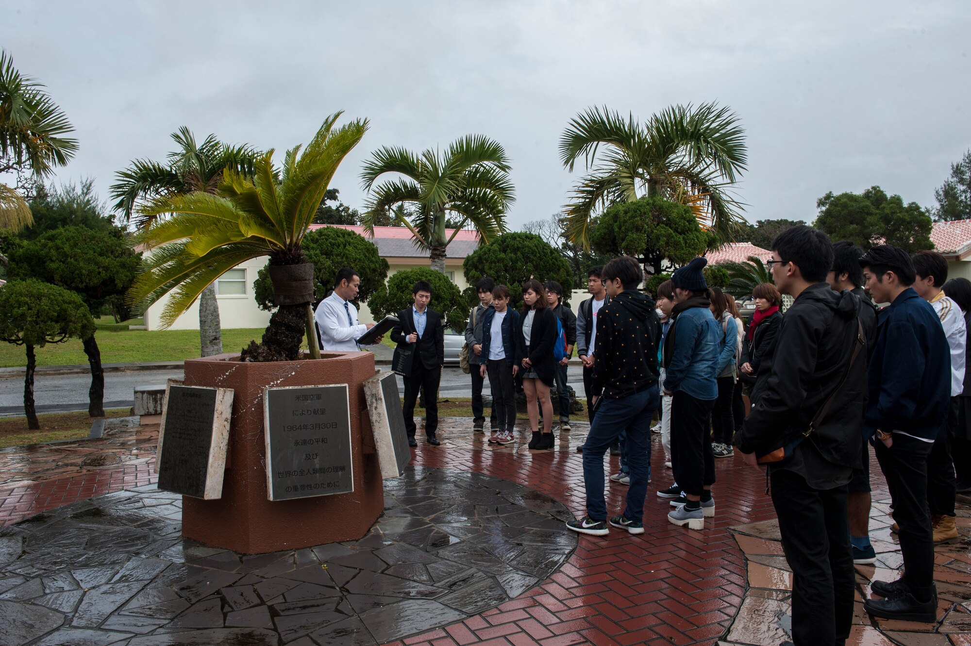 Shoya Miyagi, 18th Security Forces Squadron interpreter and translator, talks about the Peace Garden Memorial to Okinawa International University students Feb. 5, 2016, at Kadena Air Base, Japan. The Peace Garden Memorial on Kadena Air Base was the site of the Japanese surrender of Okinawa after the Battle of Okinawa in 1945. (U.S. Air Force photo by Airman 1st Class Lynette M. Rolen)