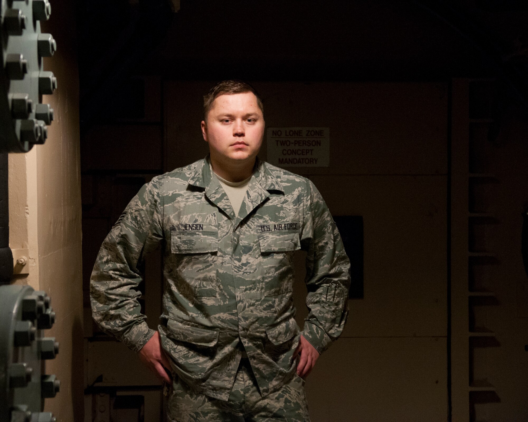 Staff Sgt. Jerimiah Jensen, 320th Missile Squadron facility manager, poses for a portrait in the tunnel junction of a missile alert facility belonging to F.E. Warren Air Force Base, Jan. 28, 2016. Facility managers keep missile alert facilities in operation order for the nuclear deterrent mission. (U.S. Air Force photo by Lan Kim)