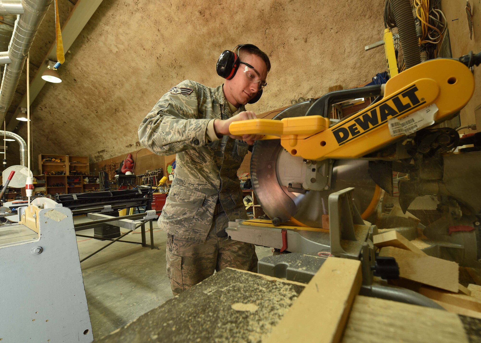 Senior Airman Michael Estes, a 386th Expeditionary Civil Engineer Squadron structures journeyman, cuts pieces of wood for a structural frame at an undisclosed location in Southwest Asia, Jan. 25, 2016. The structures flight is an integral part of the civil engineer squadron’s mission to build, maintain and repair the base infrastructure. (U.S. Air Force photo by Staff Sgt. Jerilyn Quintanilla)