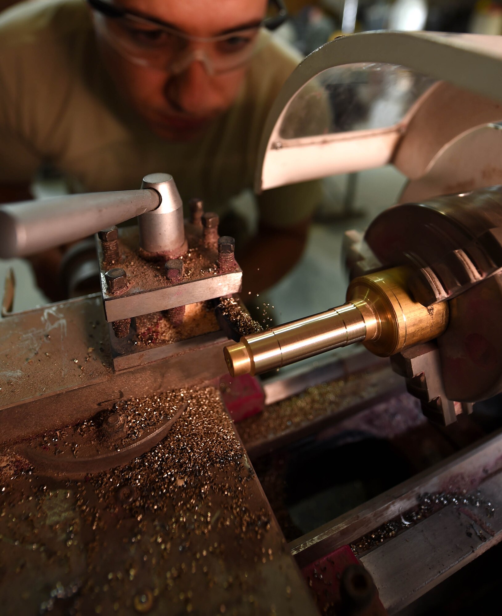 Staff Sgt. Daniel Martins, a 386th Expeditionary Civil Engineer Squadron structures craftsman, uses a metal lathe to fabricate parts at an undisclosed location in Southwest Asia, Jan. 25, 2016. The structures flight is an integral part of the civil engineer squadron’s mission to build, maintain and repair the base infrastructure. (U.S. Air Force photo by Staff Sgt. Jerilyn Quintanilla)