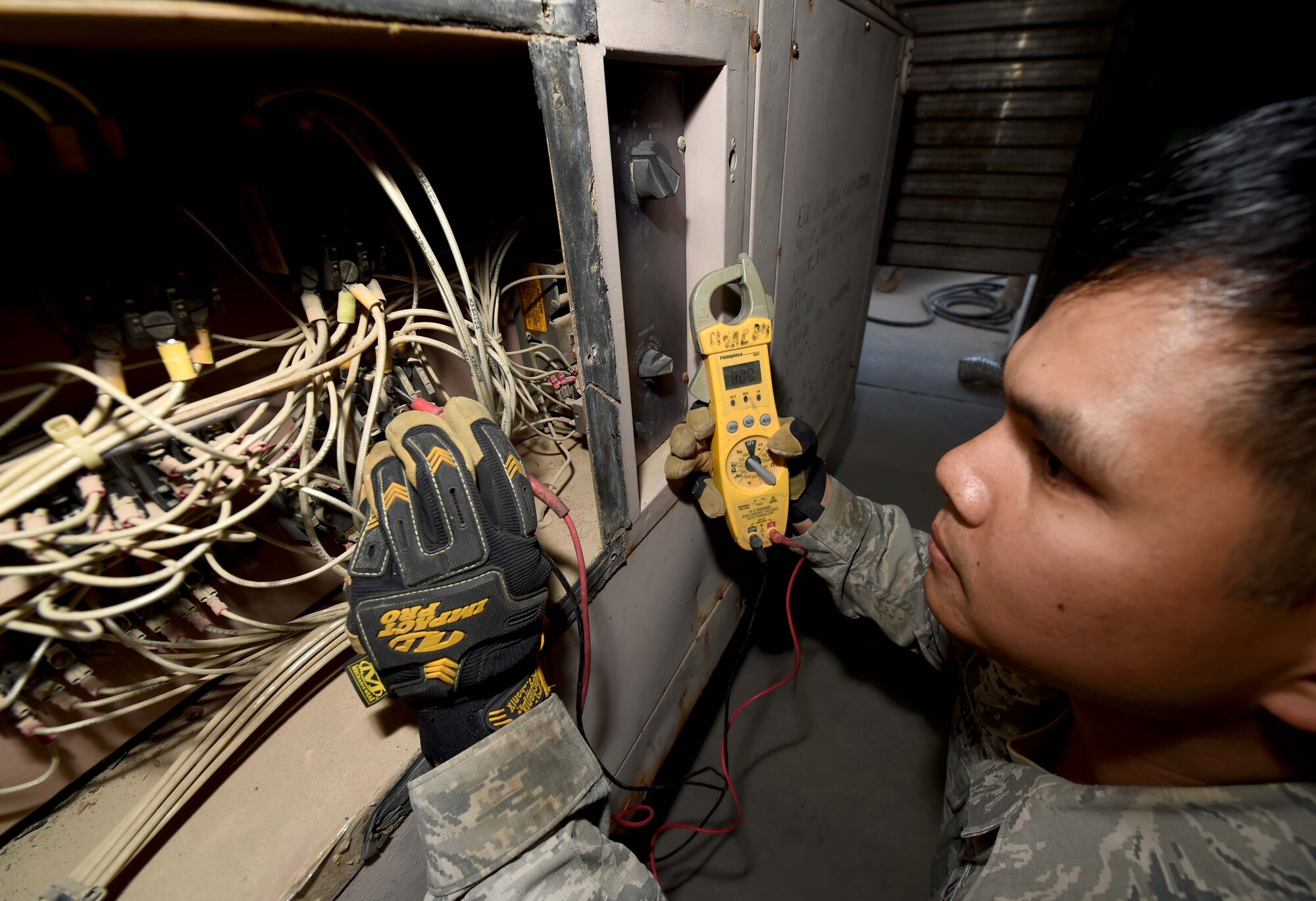 Senior Airman Adrian Panganiban, a 386th Expeditionary Civil Engineer Squadron Heating, Ventilation and Air Conditioning journeyman, checks the continuity of an environmental control unit at an undisclosed location in Southwest Asia, Jan. 25, 2016. The HVAC flight is responsible for installing, operating, maintaining, and repairing heating, ventilation and air conditioning systems throughout the installation. (U.S. Air Force photo by Staff Sgt. Jerilyn Quintanilla)