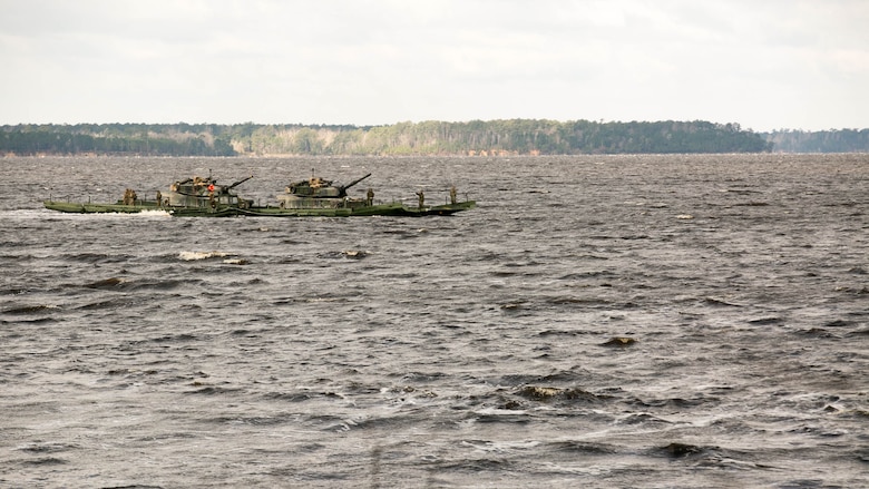 Marines with Bridge Company, 8th Engineer Support Battalion, transport two M1A1 Abrams tanks across New River, using a seven-bay raft system during a water-crossing operation at Marine Corps Base Camp Lejeune, N.C., Feb. 4, 2016. The raft increases mobility of tactical vehicles by allowing the vehicles to cross any body of water regardless of size. 