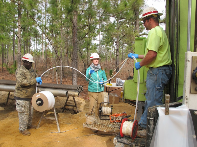 From left to right: Drill Assistant Lemon Moses, Geologist Meghan Riehl and Drill Rig Operator John Verrett lower a sample pump into a test site to collect ground water samples near Fort Jackson, South Carolina Jan. 26. The team operates USACE’s only TerraSonic drill rig that can perform work on the toughest terrains throughout the nation.
