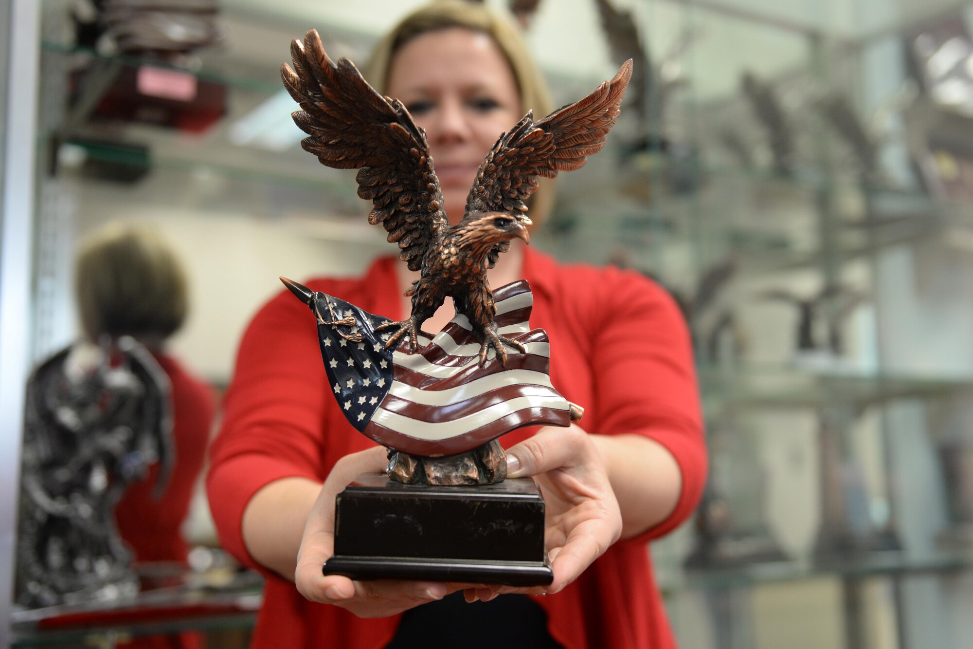 Hope Holden, Arts and Crafts Center manager, displays a trophy Feb. 2, 2016, Keesler Air Force Base, Miss. The awards and engraving shop has hundreds of trophies and plaques that can be personalized in their L.A.S.E.R. engraver. (U.S. Air Force photo by Airman 1st Class Travis Beihl)
