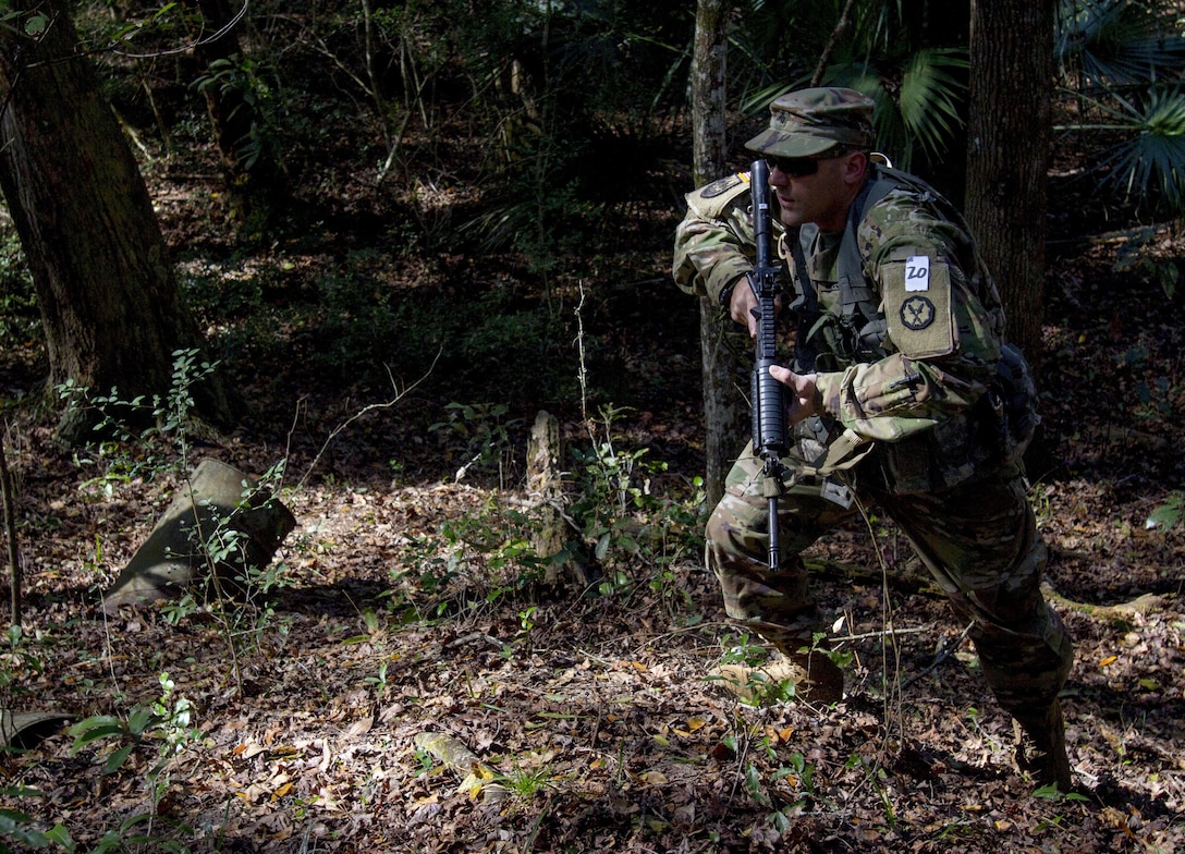 Sgt. Joseph Oneto, a military police with the 724th Military Police Detainee Operations Battalion, from Naples, Fla., charges a hill during a land navigation event at Camp Blanding, Fla., Feb. 9. The land navigation event is part of this year's 200th  Military Police Command's Best Warrior Competition. The winning noncommissioned officer and junior enlisted Soldiers will move on the U.S. Army Reserve Command competition in May. (U.S. Army Photo by Sgt. Audrey Ann Hayes)