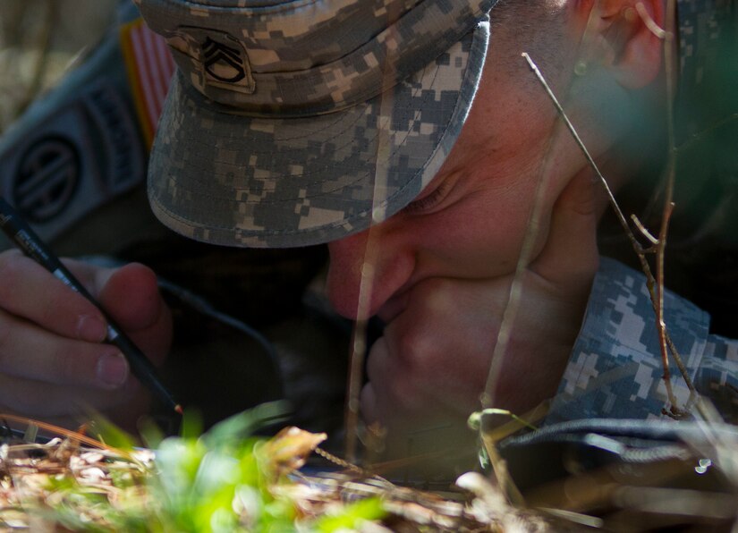 Staff Sgt. Jacob Costas with the 384th Military Police Battalion, from DeWitt, Iowa, plots points on map during a land navigation event for this year's 200th Military Police Command's Best Warrior Competition held at Camp Blanding, Fla., Feb. 9. The winning noncommissioned officer and junior enlisted Soldiers will move on the U.S. Army Reserve Command competition in May. (U.S. Army Photo by Sgt. Audrey Ann Hayes)