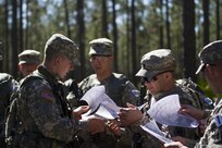 U.S. Army Reserve military police Soldiers receive maps of a land navigation course during this year's 200th Military Police Command's Best Warrior Competition at Camp Blanding, Fla., Feb. 9. Land navigation is one of the many events in the competition that reflects the competitors basic soldier skills.The winning noncommissioned officer and junior enlisted Soldiers will move on the U.S. Army Reserve Command competition in May. (U.S. Army Photo by Sgt. Audrey Ann Hayes)
