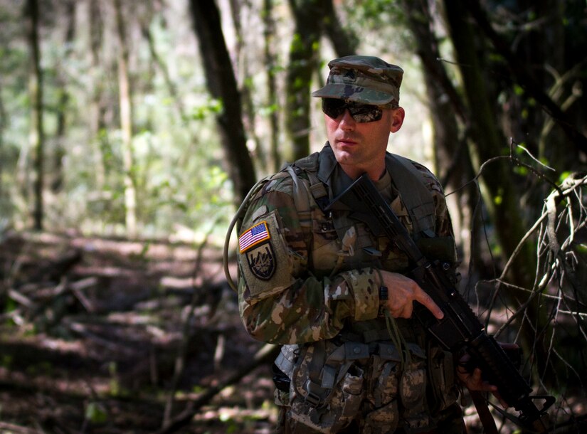 Sgt. Joseph Oneto, a military police with the 724th Military Police Detainee Operations Battalion, from Naples, Fla., contemplates which route he will take during a land navigation event, at Camp Blanding, Fla., Feb. 9. The land navigation event is part of this year's 200th  Military Police Command's Best Warrior Competition. The winning noncommissioned officer and junior enlisted Soldiers will move on the U.S. Army Reserve Command competition in May. (U.S. Army Photo by Sgt. Audrey Ann Hayes)