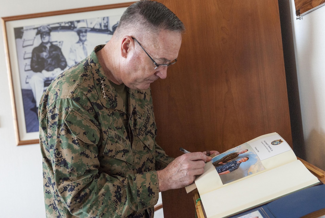Marine Gen. Joseph F. Dunford Jr., chairman of the Joint Chiefs of Staff, signs the guestbook of Navy Adm. Harry B. Harris, commander of U.S. Pacific Command, during an office call visit at the command's headquarters on Camp H.M. Smith, Hawaii, Feb. 9, 2016. DoD Photo by Navy Petty Officer 2nd Class Dominique A. Pineiro