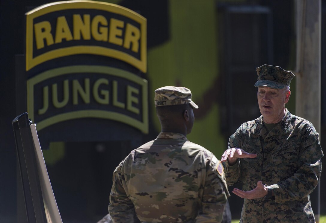Marine Gen. Joseph F. Dunford Jr., chairman of the Joint Chiefs of Staff, speaks with an instructor at the 25th Infantry Division's Tropic Lightning Academy and Jungle Operations Training Center on Schofield Barracks, Hawaii, Feb. 9, 2016. The center trains soldiers on survival, communication, navigation, waterborne operations, traversing, knots, evasion, marksmanship and patrol base operations in a jungle environment. DoD Photo by Navy Petty Officer 2nd Class Dominique A. Pineiro