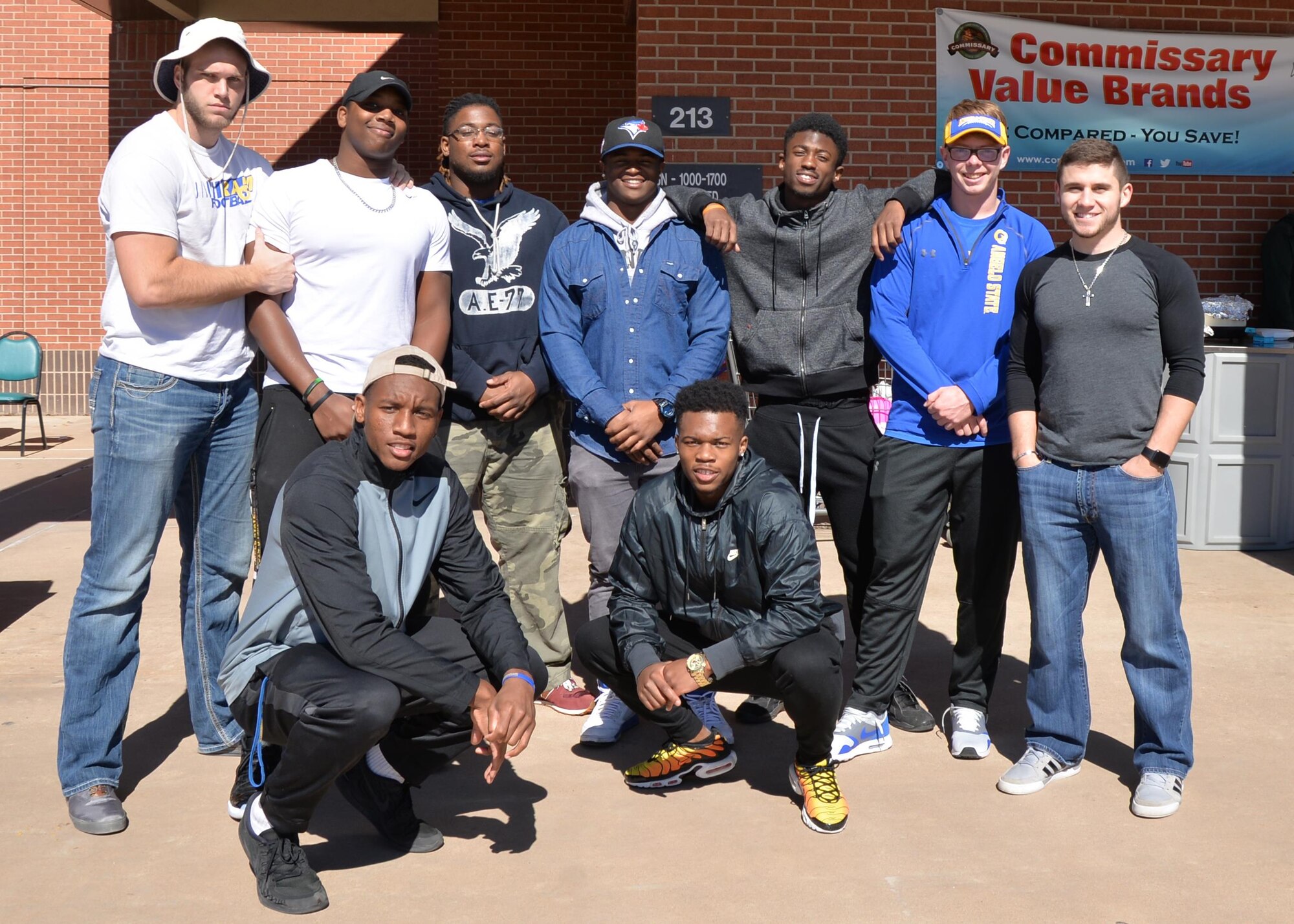 Angelo State University football team members visit the base as part of a pre-game celebration for the Super Bowl at the Commissary on Goodfellow Air Force Base, Texas, Feb. 6, 2016. The athletes participated in a variety of party games like hula hoop, musical chairs and more. (U.S. Air Force photo by Airman 1st Class Randall A. S. Moose/Released)