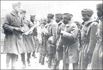 372nd: Soldiers of the 372nd Infantry preparing to board ship in France for their return home and discharge in March 1919. Note they are wearing their 93rd Division "Blue Helmet" shoulder patches. One man has a souvenir German helmet hanging from his belt. 
