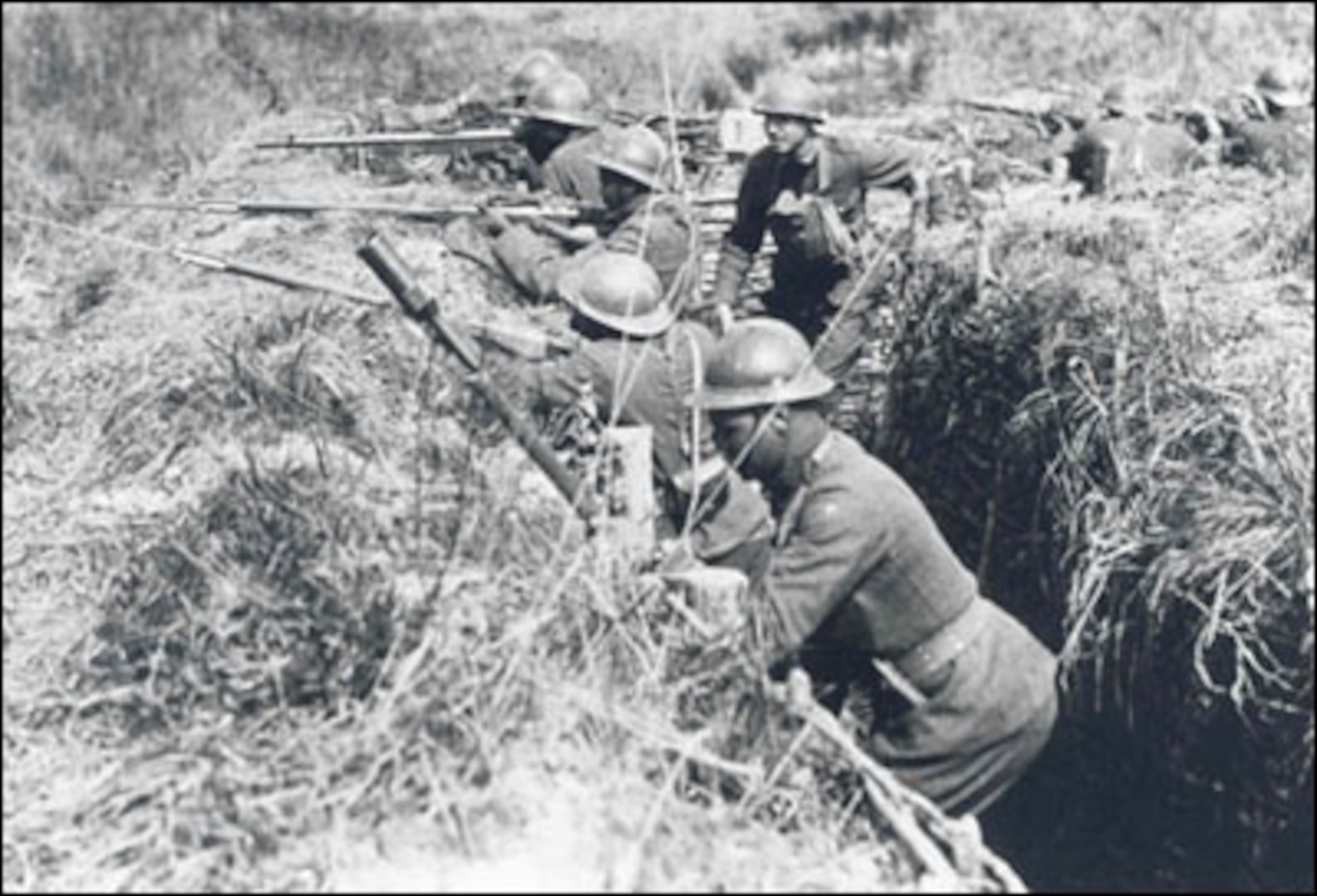 African-American Soldiers (and one of their white officers) of the 369th Infantry practice what they will soon experience, fighting in the trenches of the Western Front. They are wearing French helmets and using French issued rifles and equipment, the logic being that since they were fighting under French command, it was easier to resupply them from the French system than trying to get American-issued items.