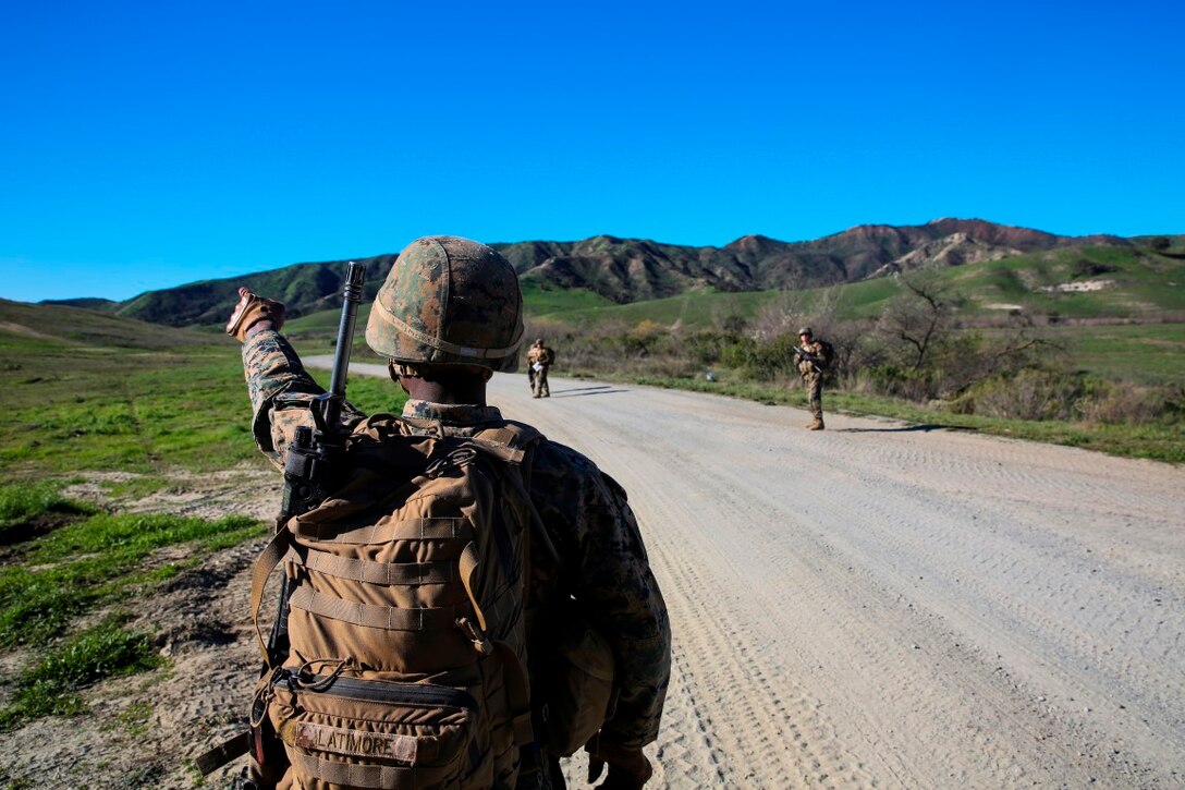 MARINE CORPS BASE CAMP PENDLETON, Calif. -- Cpl. Calvin Latimore, a launcher crewman, points his team toward their next objective during a combat endurance challenge Feb. 5, 2016. The challenge consisted of hiking nearly seven miles, testing weapons systems, combat lifesaving skills, land navigation and simulated casualty evacuation. The Marines with Battery Q, 5th Battalion, 11th Marine Regiment conducted the training aboard MCB Camp Pendleton. (Marine Corps photo by Pvt. Robert Bliss)