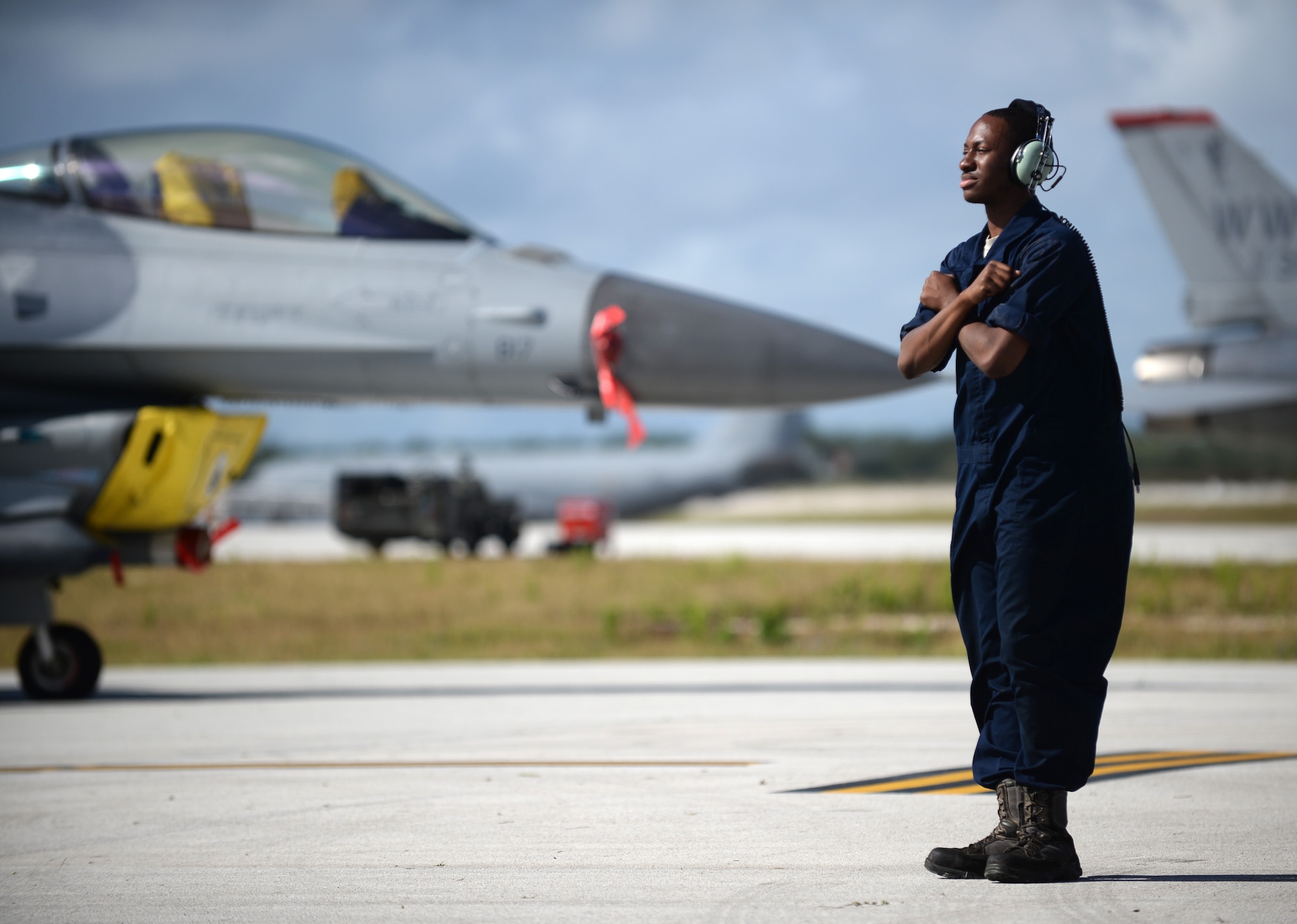 Senior Airman Darion Hubbard, a 35th Aircraft Maintenance Squadron assistant dedicated crew chief from Misawa Air Base, Japan, prepares an F-16 Fighting Falcon for takeoff Feb. 4, 2016, at Andersen Air Force Base, Guam. Several F-16s from the 13th FS are deployed to Andersen AFB in support of Cope North 2016. Cope North is an annual event that focuses on humanitarian assistance and disaster relief and large force employment in an effort to enhance interoperability among forces from the U.S., Japan, Australia, South Korea, Philippines and New Zealand. (U.S. Air Force photo/Senior Airman Joshua Smoot)