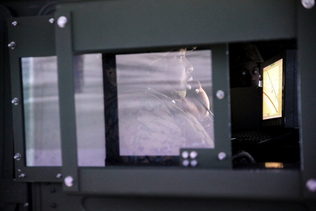 Sgt. Keiontez Dial, a motor vehicle operator with 8th Engineer Support Battalion, communicates using a radio in a training Humvee during a convoy operations training simulation at Camp Lejeune, N.C., Feb. 9, 2016. During the simulation, Marines drove through a desert environment, while challenged by an opposing force along the way. (U.S. Marine Corps photo by Cpl. Paul S. Martinez/Released)