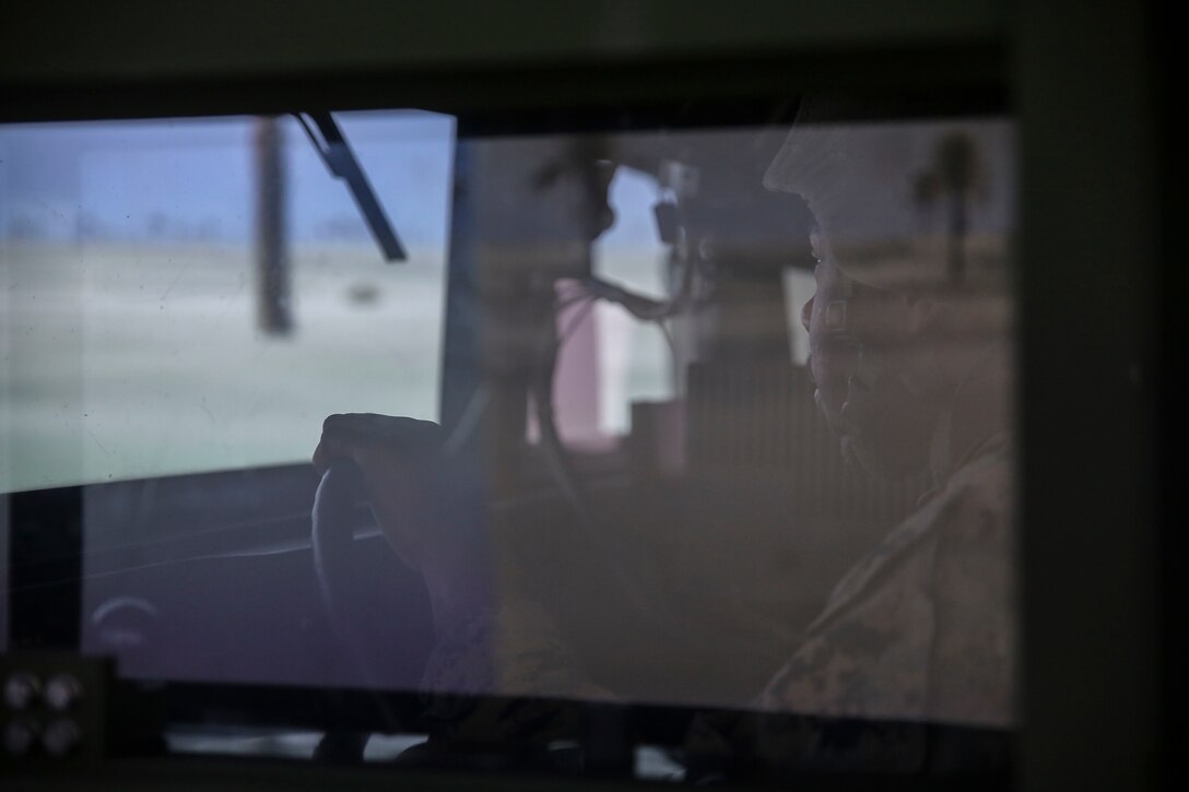 Cpl. Dequindre Jelks, a motor vehicle operator with 8th Engineer Support Battalion, drives a training Humvee during a convoy operations training simulation at Camp Lejeune, N.C., Feb. 9, 2016. Marines participated in a fully-digitized convoy simulation that allowed them to drive a high-mobility multipurpose wheeled vehicle or a seven-ton in a deployed environment. (U.S. Marine Corps photo by Cpl. Paul S. Martinez/Released)