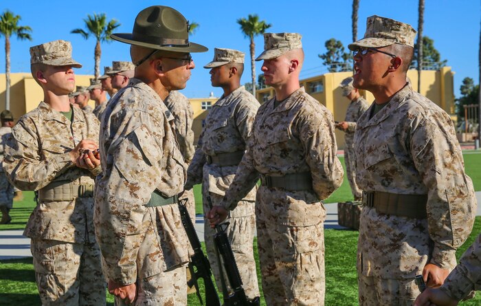 A drill instructor of India Company, 3rd Recruit Training Battalion, quizzes a recruit on his knowledge during a series commander inspection at Marine Corps Recruit Depot San Diego, Feb. 8. Drill instructors test recruit to see how much knowledge they’ve retained thus far in recruit training. Recruits take part in a series of classes to learn about such things as the history of the Marine Corps and uniform standards. Annually, more than 17,000 makes recruited from the Western Recruiting Region are trained at MCRD San Diego. India Company is scheduled to graduate March 11.