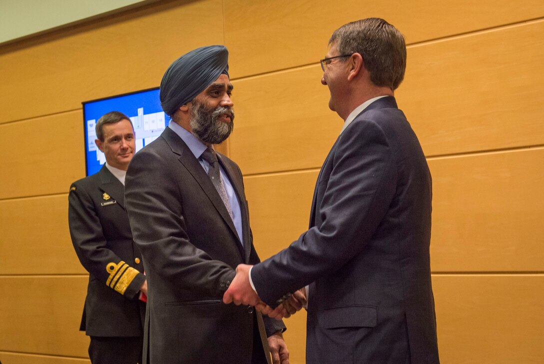 Defense Secretary Ash Carter exchanges greetings with Canadian Defense Minister Harjit Sajjan as they prepare to discuss matters of mutual importance during a bilateral meeting at NATO headquarters in Brussels, Feb. 10, 2016. DoD photo by Air Force Senior Master Sgt. Adrian Cadiz
