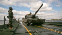 Marines with Bridge Company, 8th Engineer Support Battalion, prepare to unload two M1A1 Abrams tanks following their transport across New River by using a seven-bay raft system during a water-crossing operation at Marine Corps Base Camp Lejeune, N.C., Feb. 4, 2016. The unit boasts a wide range of raft systems and bridging that it is able to do to allow tactical vehicles to cross large bodies of water. 