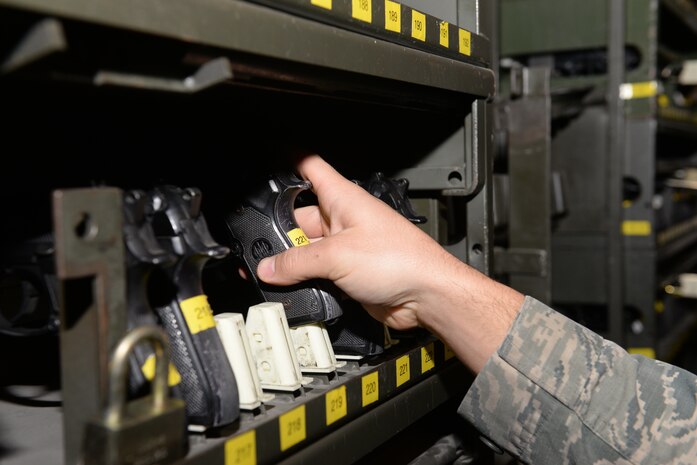 Airman 1st Class Dillon Goss, 99th Security Forces Squadron armorer, puts away a firearm in the armory at Nellis Air Force Base, Nev., Feb. 9, 2016. Privately owned firearms are exclusively prohibited on base except as otherwise directed by the installation commander, and concealed carry of firearms is prohibited on the installation regardless of whether or not the individual has a concealed carry permit. The policy is in place to ensure the safety and security of the base community and facilities. (U.S. Air Force photo by Airman 1st Class Nathan Byrnes)