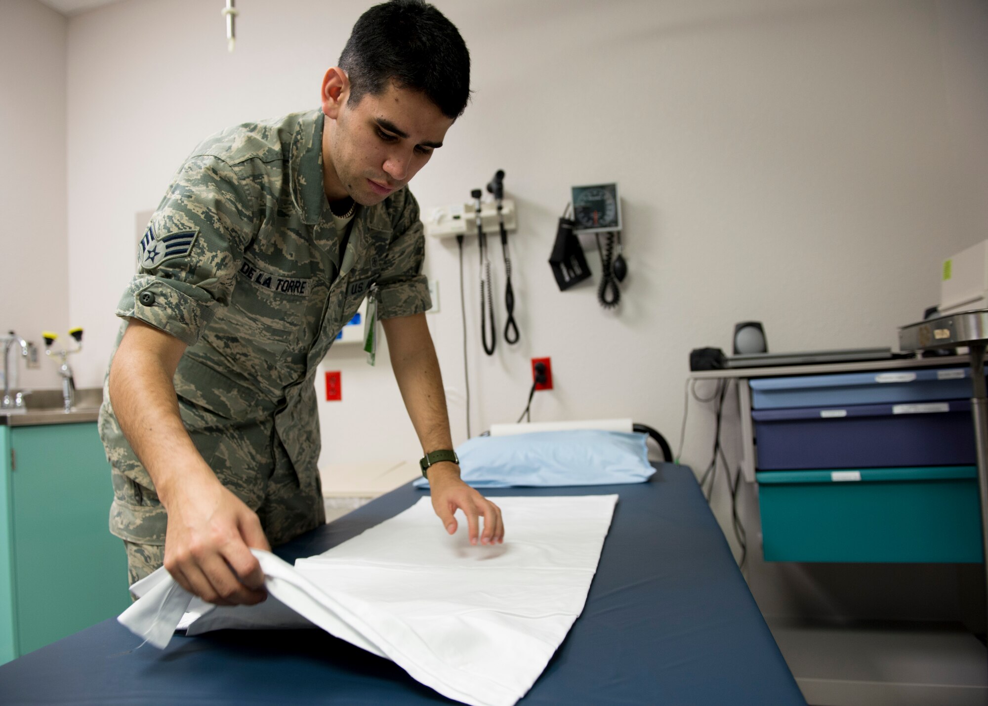 Senior Airman Pedro De La Torre Jr., a 49th Medical Group technician, prepares a gurney inside the medical clinic at Holloman Air Force Base on Jan. 21. Medical technicians provide an array of services that include everything from in-processing patients to assisting doctors with procedures. (U.S. Air Force photo by Airman 1st Class Randahl J. Jenson)