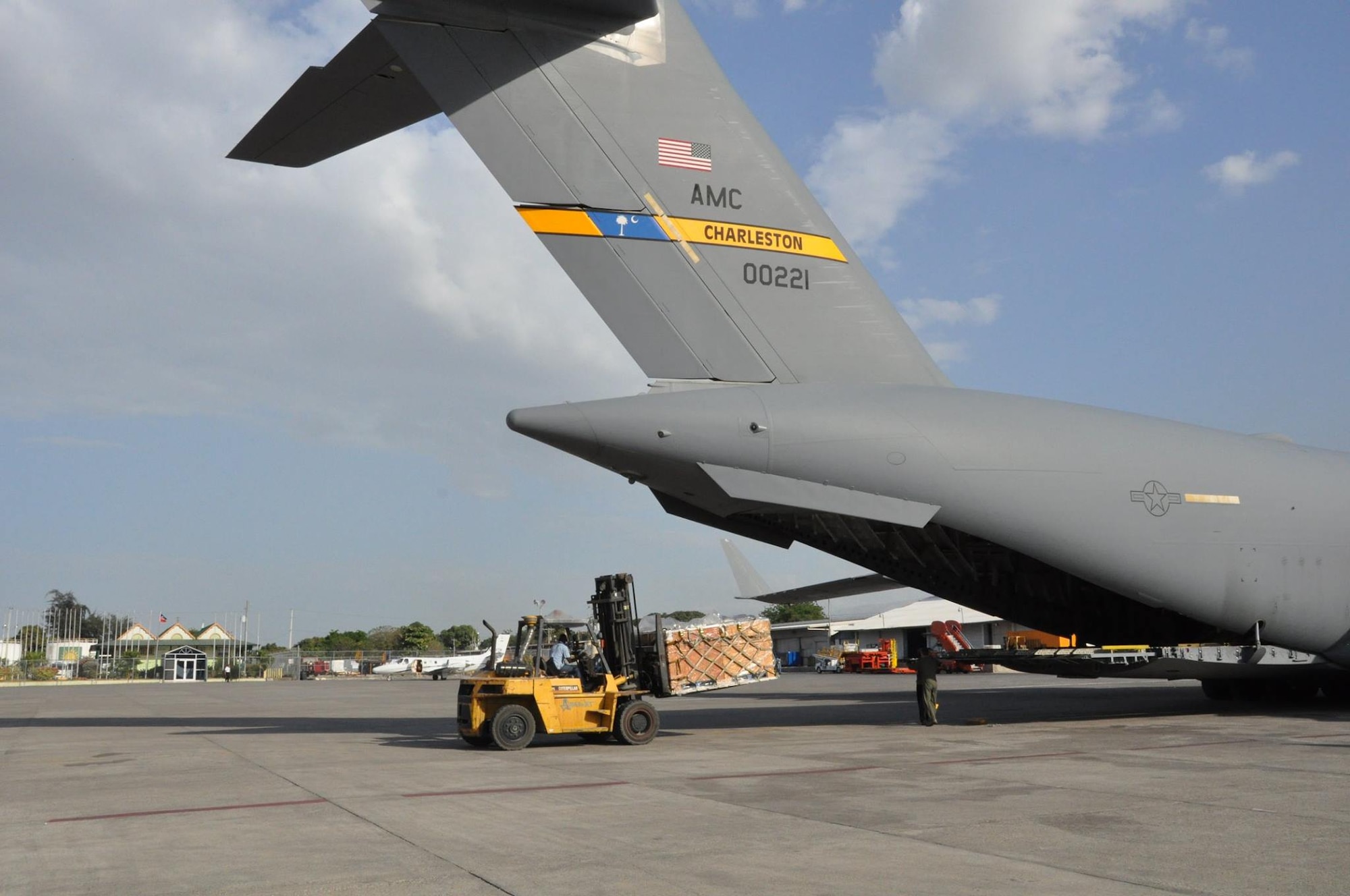 Humanitarian aid is unloaded from a Joint Base Charleston, S.C. C-17 Globemaster III in Port Au Prince Haiti.(U.S. Air Force photo by Maj. Wayne Capps)