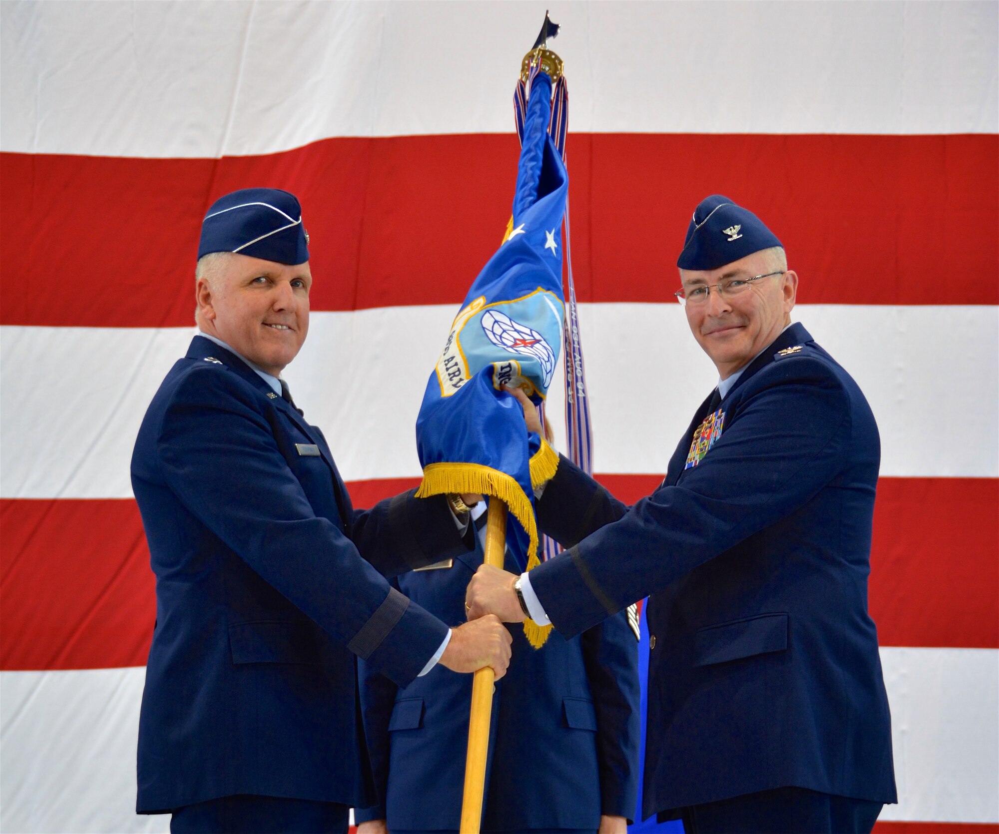 Maj. Gen. John C. Flournoy Jr., Fourth Air Force commander, passes the guidon to Col. Jonathan M. Philebaum Feb 7., during the 932nd Airlift Wing change of command ceremony at Scott Air Force Base, Illinois. Prior to taking command of the unit, Philebaum led the 512th Operations Group at Dover Air Force Base, Delaware. (U.S. Air Force photo by Tech. Sgt. Jodi Ames)