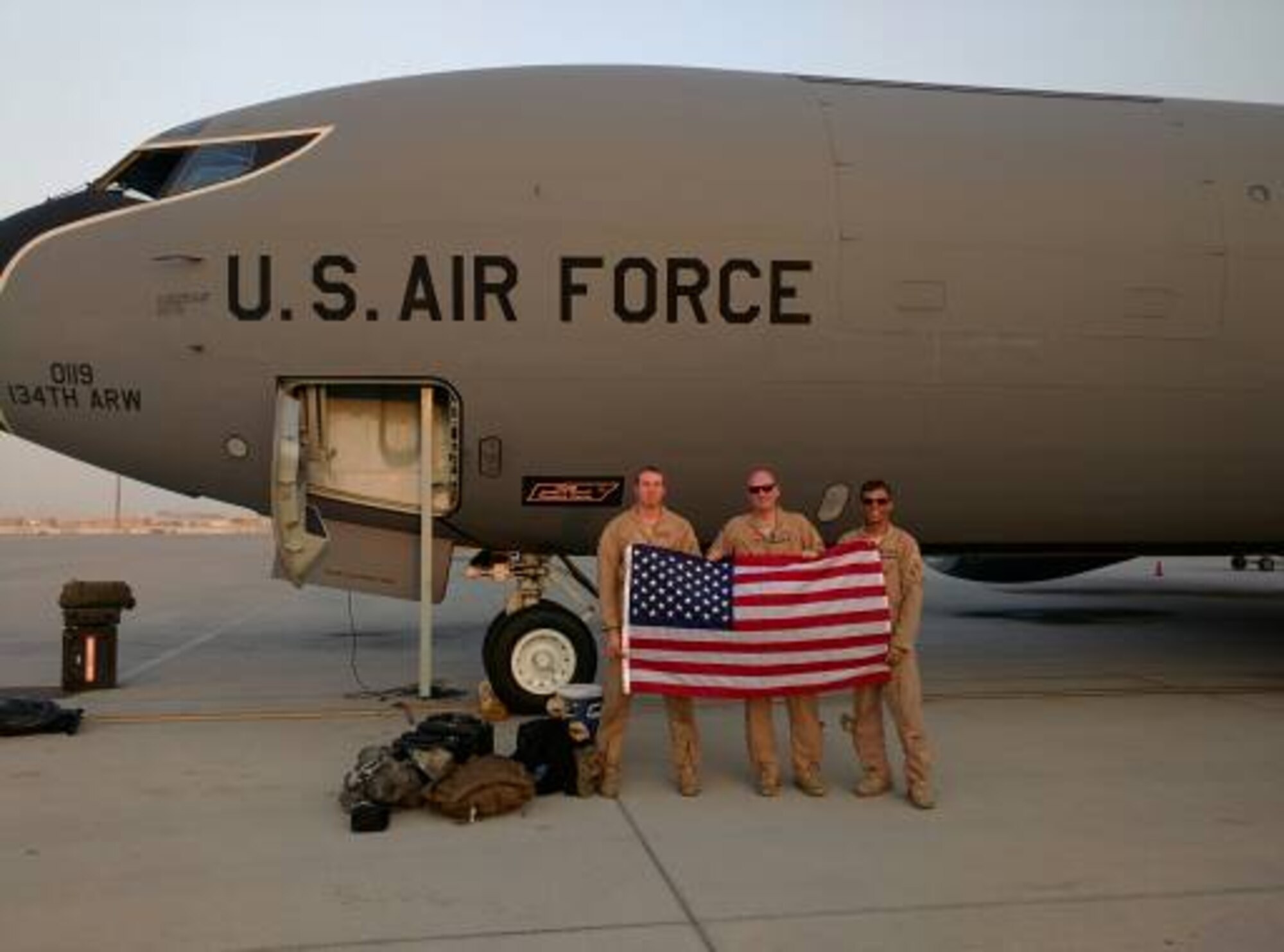 (Left) Senior Airman Jonathan Nigl, 384th Air Refueling Squadron boom operator, Maj. Robert Bradley and Capt. Nathanial Beer, 384th ARS pilots, pose for a photo in front of their aircraft. (Courtesy photo)