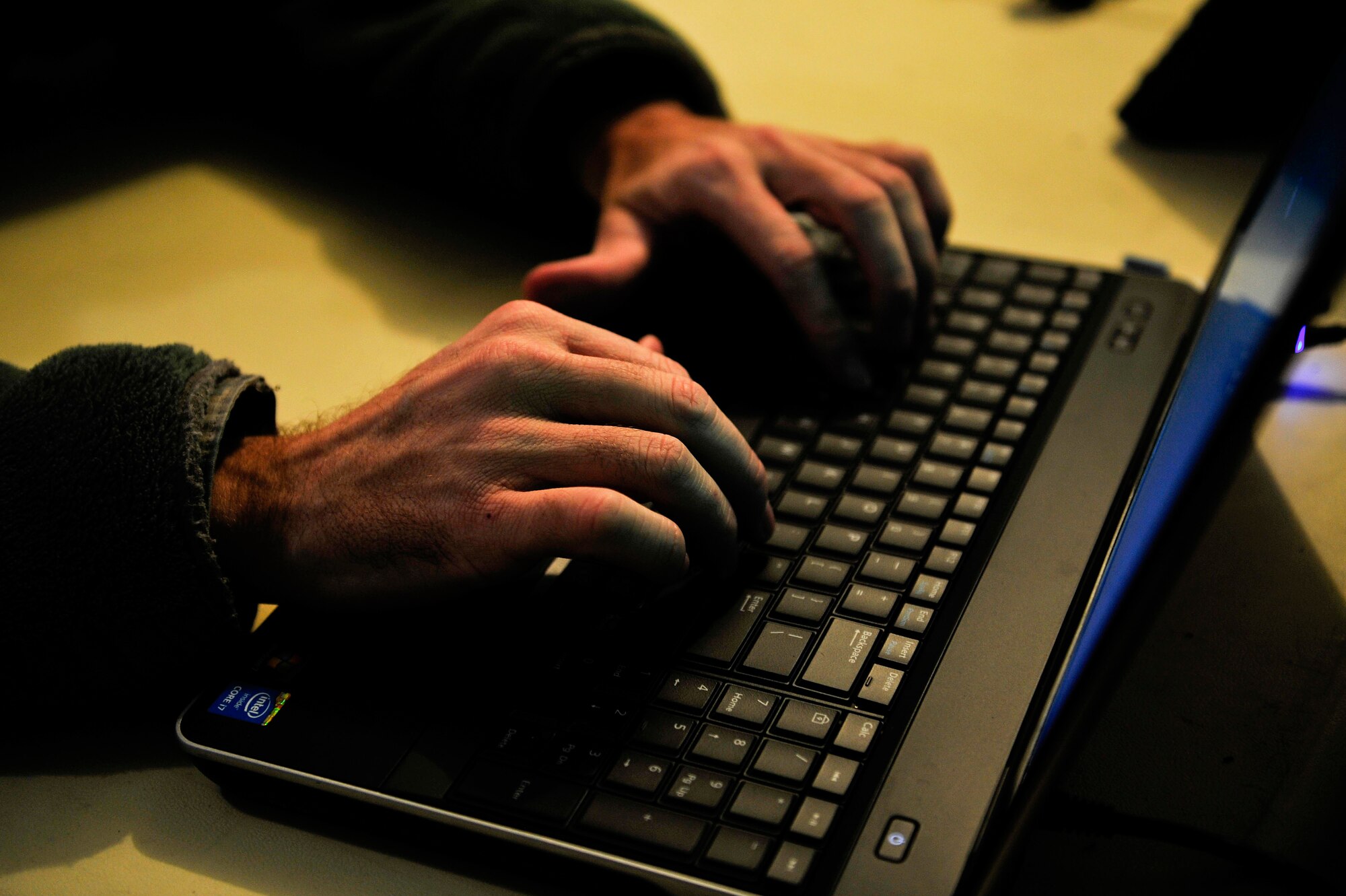 U.S. Army Staff Sgt. Ronald Taylor, the communications noncommissioned officer in charge from the 833rd Transportation Battalion, logs into a computer during the command post exercise at Fort Eustis, Va., Feb. 9, 2016. By logging into the secure internet protocol routers, Taylor was able to access share drives and documents pertinent to the exercise. (U.S. Air Force photo by Airman 1st Class Breonna Veal)