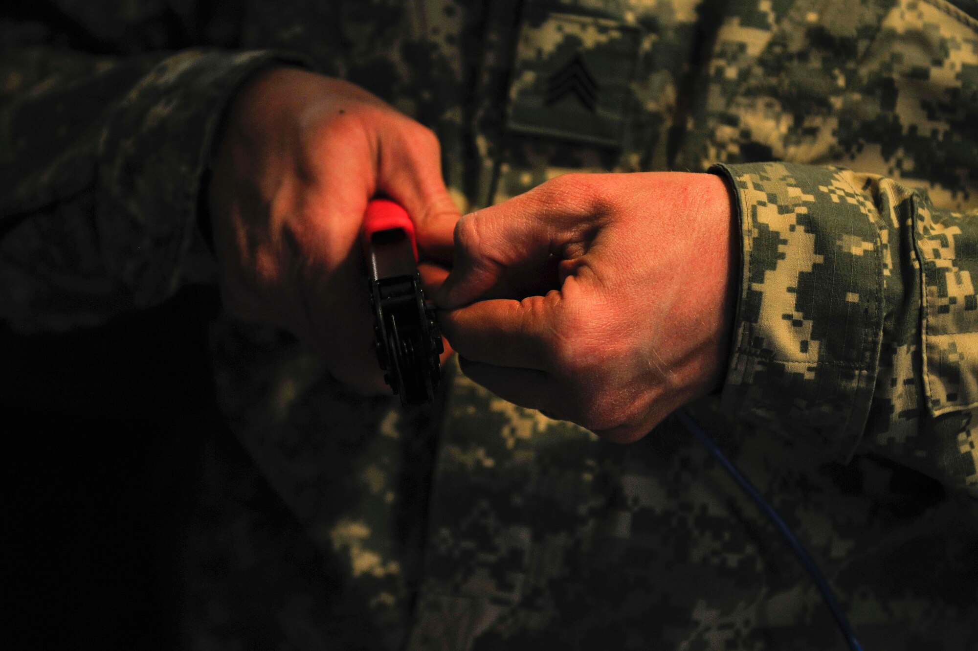 A U.S. Army Soldier from the 833rd Transportation Battalion cuts cable line during a command post exercise at Fort Eustis, Va., Feb. 9, 2016. The brigade’s communication specialists are trained to ensure seamless connections between laptops and non-secure and secure internet protocol routers. (U.S. Air Force photo by Airman 1st Class Breonna Veal)