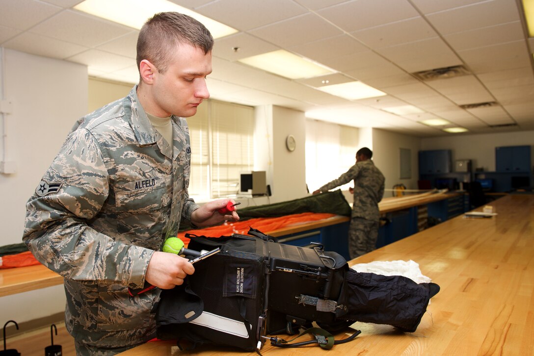 U.S Air Force Airman 1st Class Justin Alfeld, 1st Operations Support Squadron aircrew flight equipment technician, inspects an Advanced Concept Ejection System II at Langley Air Force Base, Va., Jan. 29, 2016. Members of AFE are vital to pilots by making sure all flight equipment are in working order, including parachutes and survival equipment. (U.S. Air Force photo by Airman 1st Class Derek Seifert) 