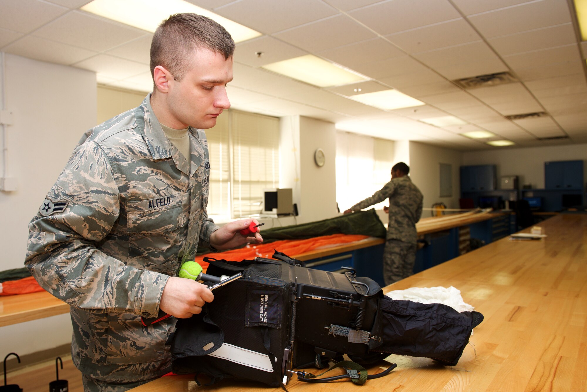 U.S Air Force Airman 1st Class Justin Alfeld, 1st Operations Support Squadron aircrew flight equipment technician, inspects an Advanced Concept Ejection System II at Langley Air Force Base, Va., Jan. 29, 2016. Members of AFE are vital to pilots by making sure all flight equipment are in working order, including parachutes and survival equipment. (U.S. Air Force photo by Airman 1st Class Derek Seifert) 