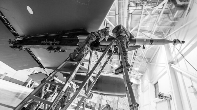 Staff Sgt. Eric Hathaway (left), 5th Aircraft Maintenance Squadron weapons load crew chief and Senior Airman Jesse Johnson, 5th AMXS load crew member, load a laser-guided GBU-12 munition onto a B-52H Stratofortress during Exercise Combat Hammer at Minot Air Force Base, N.D., Feb. 8, 2016. According to exercise officials, the objective of Combat Hammer is to evaluate the reliability and efficiency of existing combat weapons systems while also assessing the Air Force’s air-to-ground munitions program. (U.S. Air Force photo/Airman 1st Class J.T. Armstrong)
