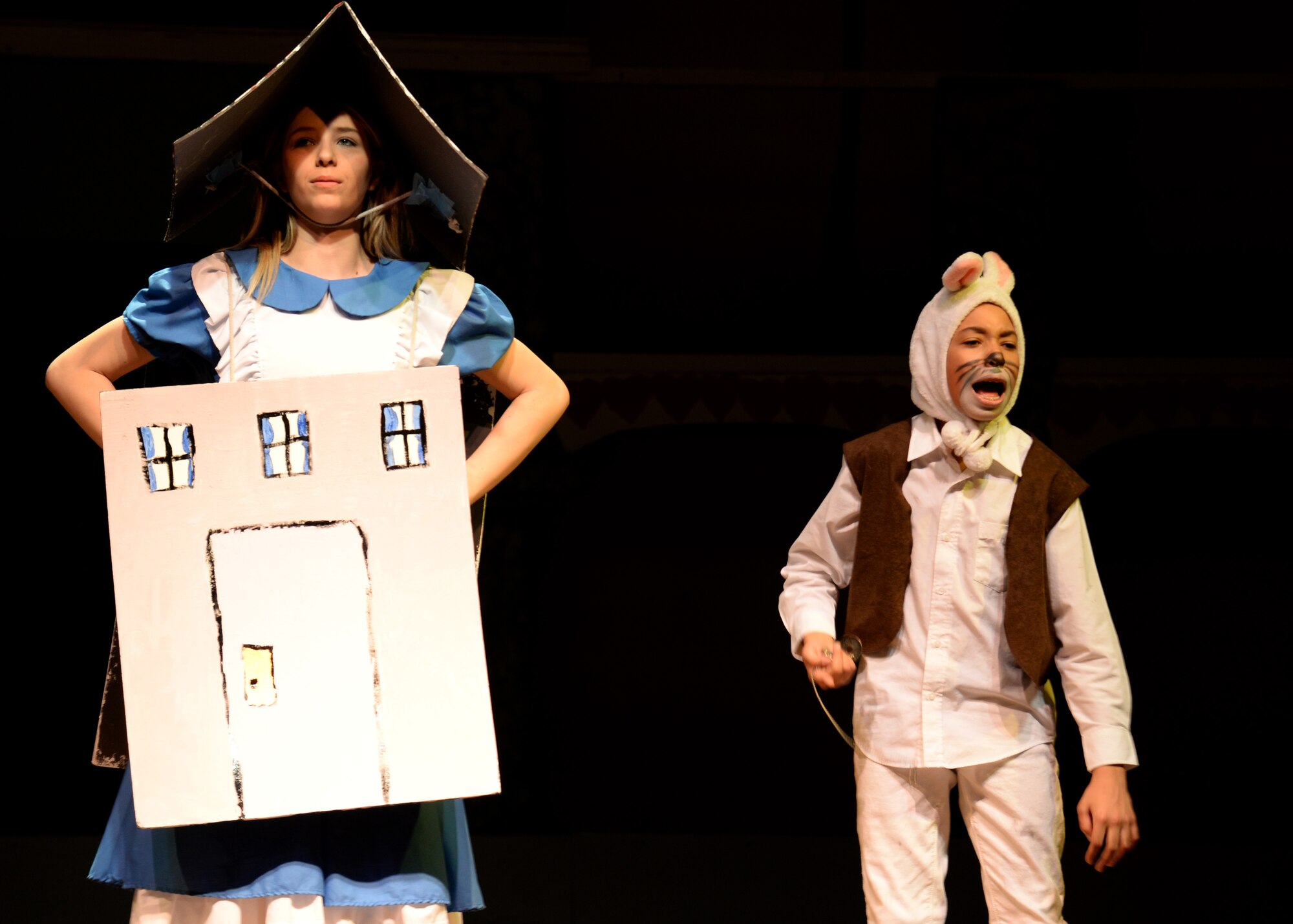 Macie Dunn and Jhondre Rollins perform a scene from “Alice in Wonderland Jr.,” Feb 4, 2016, at Aviano Air Base, Italy. The cast performed the play for four nights, which followed Alice’s journey down the rabbit hole. (U.S. Air Force photo by Airman 1st Class Cary Smith/Released)