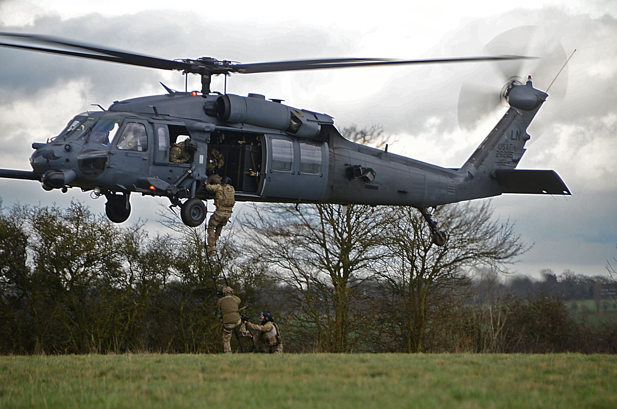 Pararescuemen assigned to the 57th Rescue Squadron climb into an HH-60G Pave Hawk during a combat search and rescue task force training exercise near Hinderclay, England, Feb. 4, 2016. The training simulated a downed pilot in a hostile environment that required employment of 56th and 57th RQS personnel for recovery assistance. (U.S. Air Force photo/Senior Airman Erin Trower)