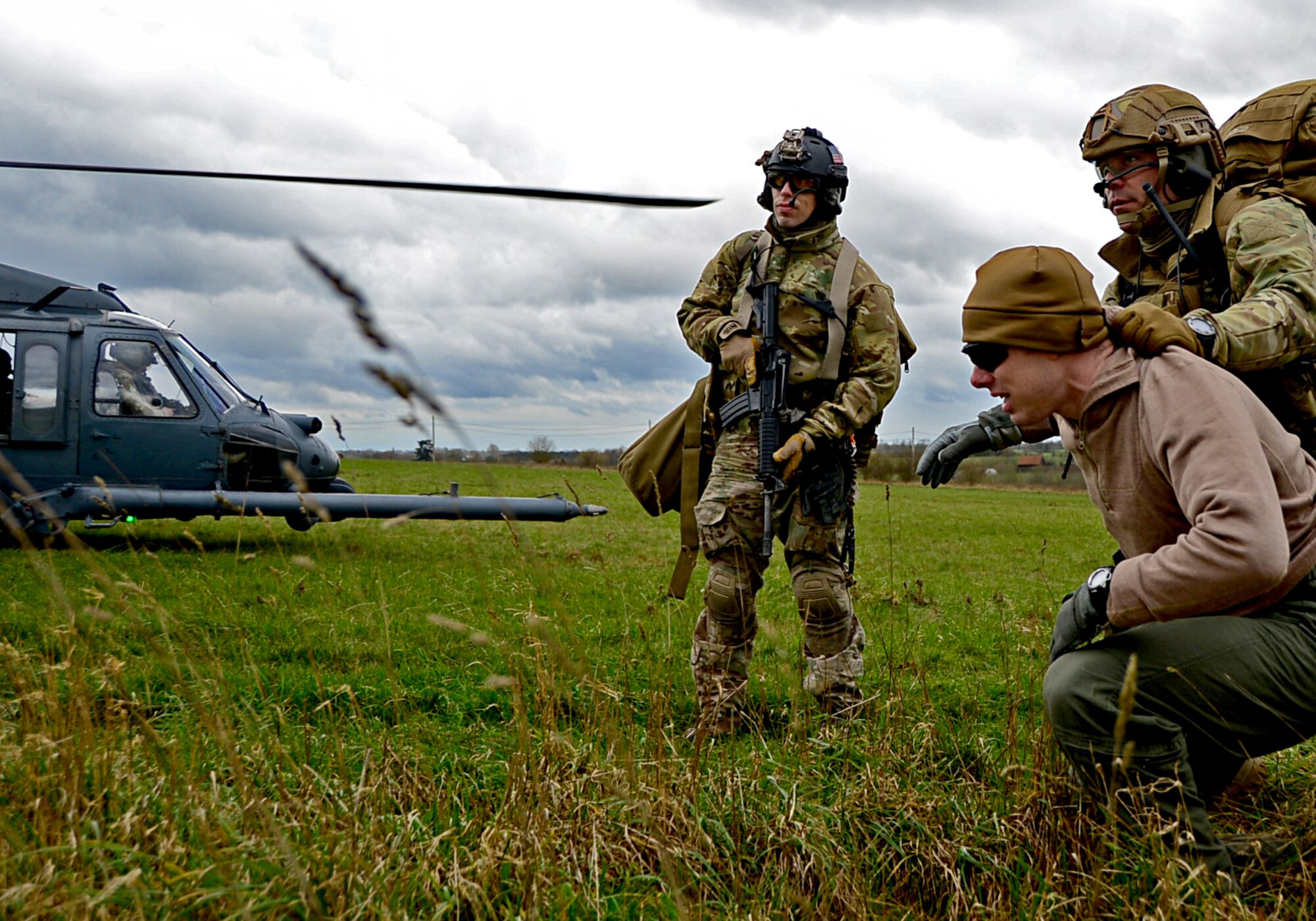 Capt. Jason Beck, 56th Rescue Squadron HH-60G Pave Hawk pilot, plays the role of a survivor during a combat search and rescue task force training exercise near Hinderclay, England, Feb. 4, 2016. The training focused on simulated threat and rescue techniques and involved various squadrons and personnel assigned to the 48th Fighter Wing and 100th Air Refueling Wing. (U.S Air Force photo/Senior Airman Erin Trower)