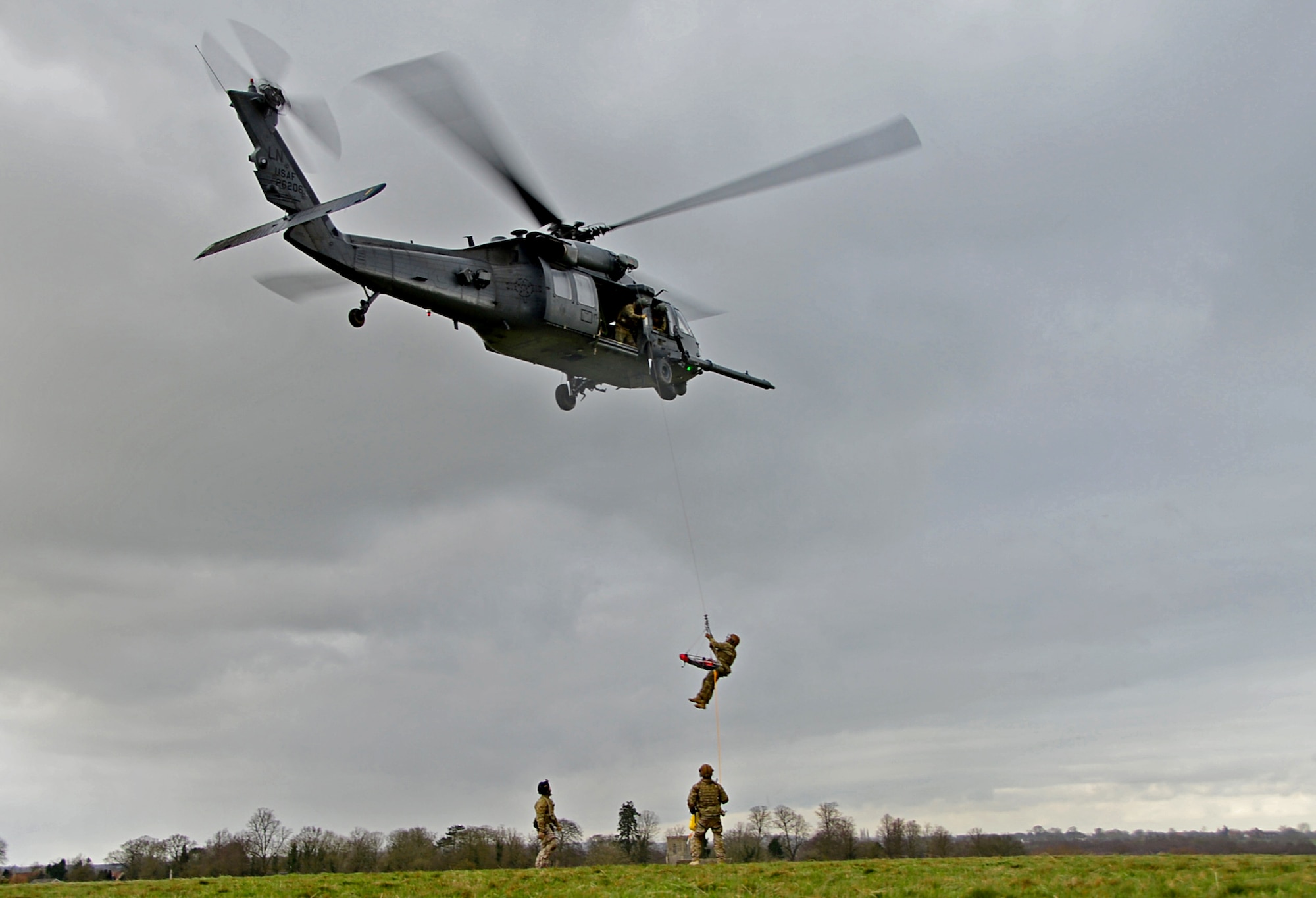 A 57th Rescue Squadron pararescueman is hoisted into an HH-60G Pave Hawk during a combat search and rescue task force exercise near Hinderclay, England, Feb. 4, 2016. Airmen assigned to the 56th and 57th RQSs performed various CSAR maneuvers in response to a simulated threat scenario. (U.S. Air Force photo/Senior Airman Erin Trower)