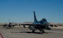 F-16C Fighting Falcons from the 64th Aggressor Squadron, taxi down the flightline at Red Flag 16-1, Jan. 28 on the Nellis AFB, Nev. The aggressors act as high level advisories and replicate threats that Red Flag participants could see in an actual combat situation. (U.S. Air Force photo by Senior Airman Alex Fox Echols III/Released)  