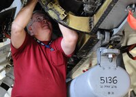 An employee of PAE, an Arlington, Virginia based organization inspects the components of a QF-16 Feb. 4 at the 82nd Aerial Targets Squadron Full-scale operations facility at Tyndall. The QF-16 is used for simulated cold missions, or safe missions which utilizes a remote operator and pilot simultaneously. The PAE contractors manage all maintenance on full-scale and sub-scale drones. The 82d maintains 20 QF-16s and 40 BQM-167s. (U.S. Air Force photo by Senior Airman Ty-Rico Lea)