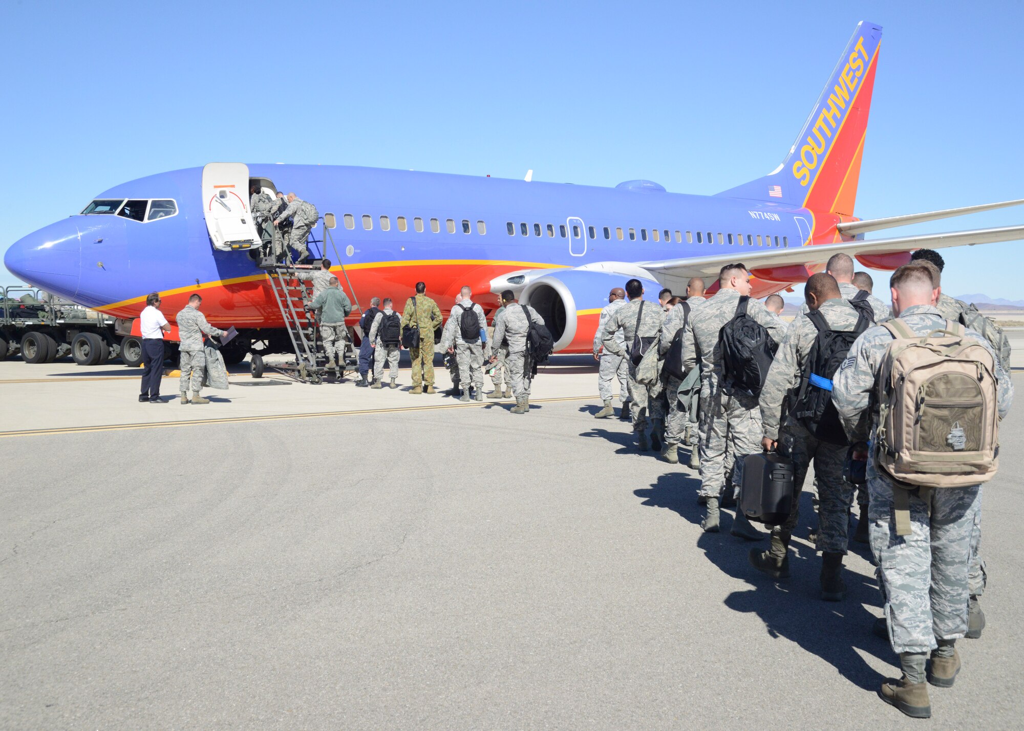 Airmen from the 31st Test and Evaluation Squadron board a Southwest 737 Feb. 9. The commercially contracted plane took the Airmen, mostly maintainers, to Mountain Home Air Force Base, Idaho, where they will spend about a month conducting a test event for the F-35 Joint Strike Fighter. (U.S. Air Force photo by Kenji Thuloweit)