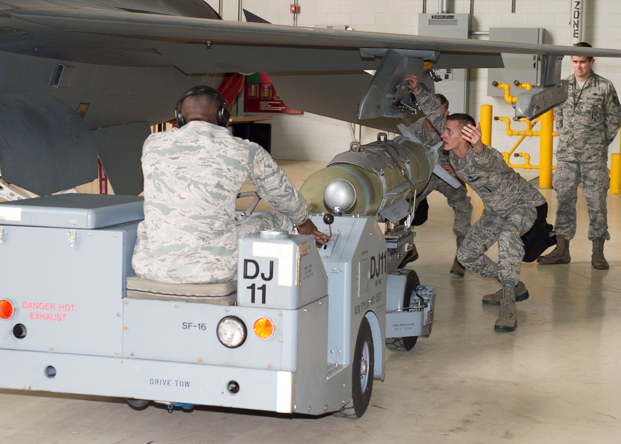 Members of the 416th Aircraft Maintenance Unit Weapons Load crew prepare to mount a GBU-31 guided bomb onto a fighter during the quarterly load competition in January, which they won. The 412th Maintenance Group will hold its annual Load Crew of the Year Competition for 2015 Feb. 19.   (U.S. Air Force photo by Ethan Wagner)