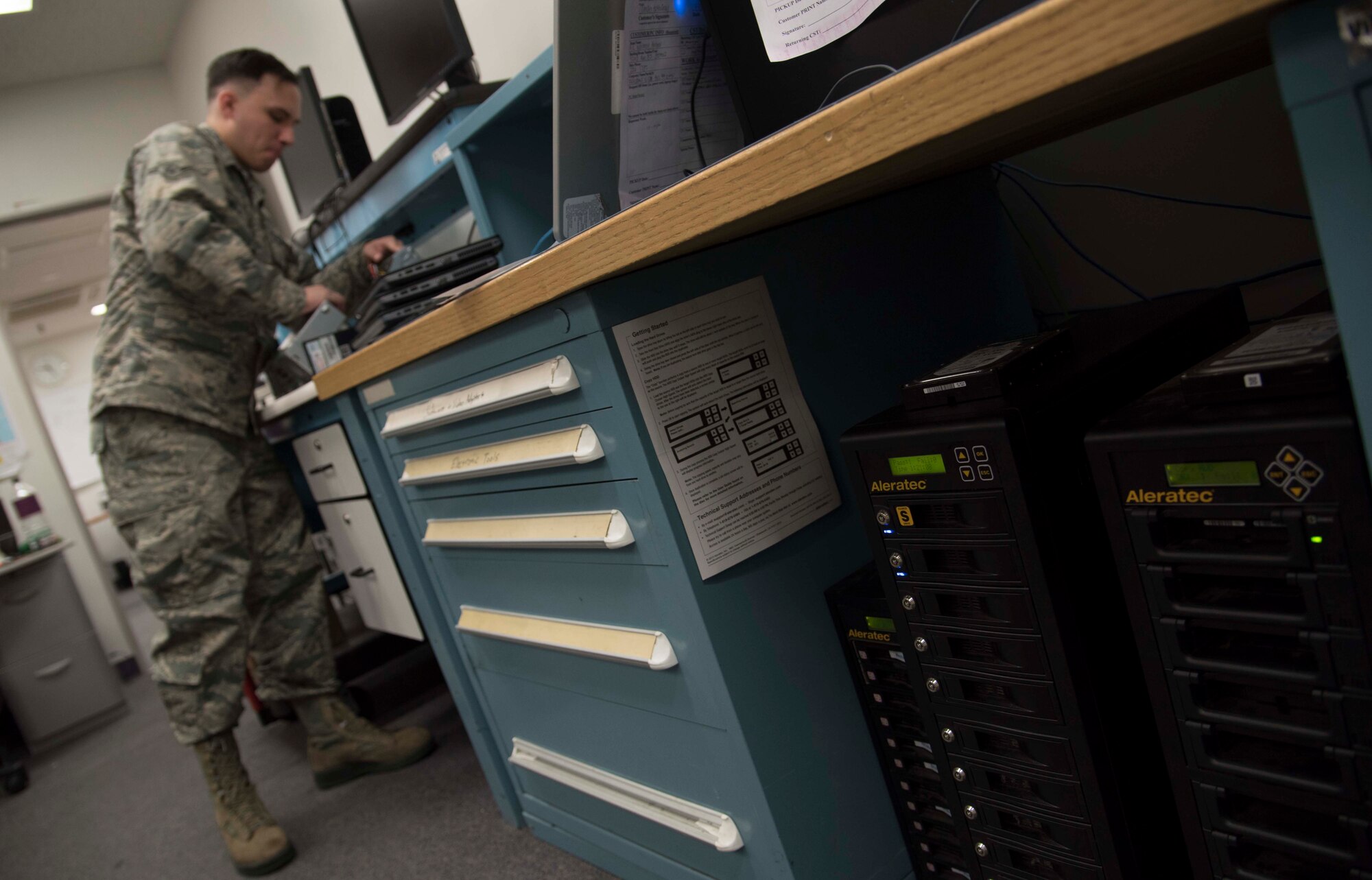 U.S. Air Force Airman Matthew Kennison, a client systems technician with the 35th Communications Squadron, works on a desktop computer at Misawa Air Base, Japan, Feb. 10, 2016.  As shops around the base purchase new products at the end of the fiscal year, computers, laptops and tablets filter through the 35th CS back shop for reimaging and connection to the network. (U.S. Air Force photo by Airman 1st Class Jordyn Fetter)