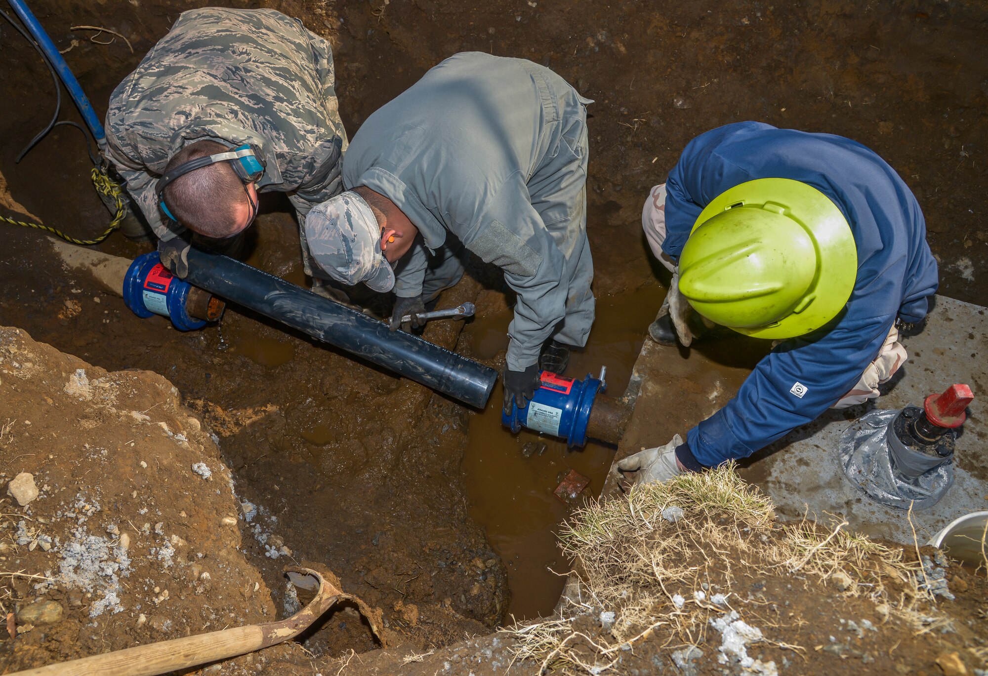 Members of the 374th Civil Engineer Squadron water fuel system maintenance section place a new pipe within a pipeline at Yokota Air Base, Japan, Feb. 9, 2016. A pipeline can burst through a variety of ways: pressure change in the atmosphere, earthquakes, and low or high temperatures. (U.S. Air Force photo by Senior Airman David Owsianka/Released)