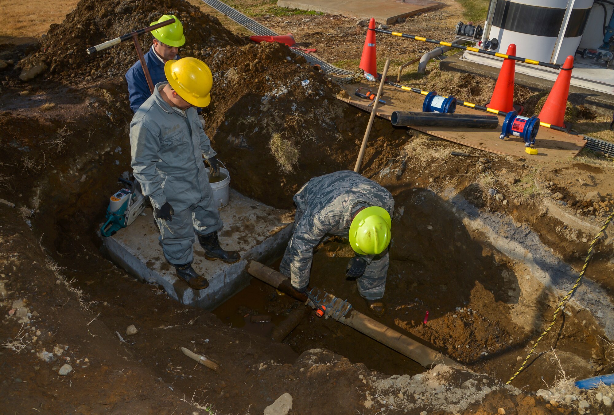 Airman 1st Class Colton Hunkeapillar, 374th Civil Engineer Squadron water fuel system maintenance journeyman, loosens bolts on a full circle clamp on a pipeline at Yokota Air Base, Japan, Feb. 9, 2016. A pipeline can burst through a variety of ways: pressure change in the atmosphere, earthquakes, and low or high temperatures. (U.S. Air Force photo by Senior Airman David Owsianka/Released)