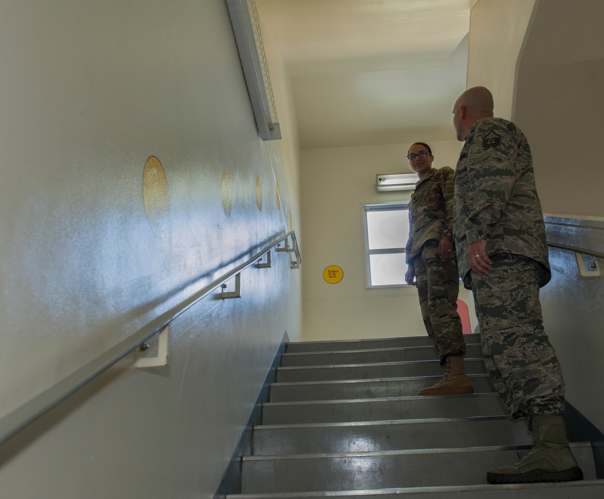 U.S. Army Specialist Katilyne Simpson, Public Health Command District Japan Veteran Services and Dorm 700 dorm council president, shows U.S. Air Force Master Sgt. George Burns, 718th Civil Engineer Squadron unaccompanied housing superintendent, the design of the dorm Feb. 9, 2016, at Kadena Air Base, Japan. Dorm 700 won the annual award for the Dorm Competition. The design of the dorm was the main reason they won because it inspired creativity among the residents. (U.S. Air Force photo by Airman 1st Class Lynette M. Rolen)