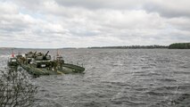 Marines with Bridge Company, 8th Engineer Support Battalion, transport two M1A1 Abrams tanks across New River, using a seven-bay raft system during a water-crossing operation at Marine Corps Base Camp Lejeune, N.C., Feb. 4, 2016. The unit provides support to any unit across the II Marine Expeditionary Force that needs to cross any body of water regardless of size. 