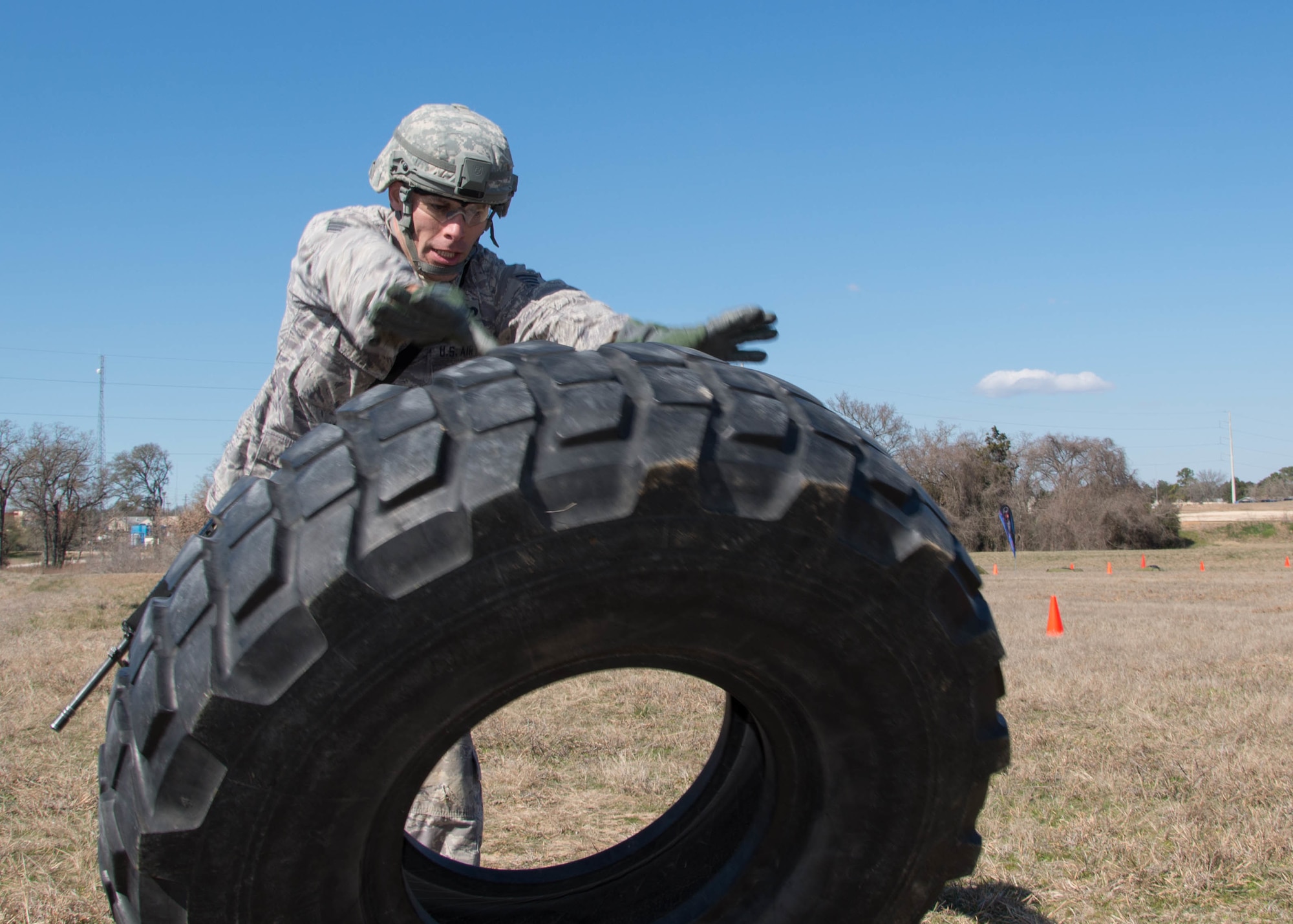U.S. Air Force Tech. Sgt. Steven Hein, a competitor from the 136th Security Forces Squadron, conducts a tire flip as part of the mystery event portion of the Best Warrior Competition at Camp Swift, Texas, Feb. 6, 2016. The BWC test the aptitude of elite Texas Air and Army National Guardsmen in events relevant to today's operating environment. (Texas Air National Guard photo by Tech. Sgt. Vanessa Reed/ Released)